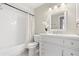Bright bathroom with a shower-tub combo, a modern vanity, and a decorative orchid at 100 Essex Dr, Longwood, FL 32779