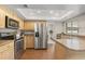 Spacious kitchen features stainless steel appliances, wood cabinets, and granite countertops at 100 Essex Dr, Longwood, FL 32779