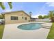 Private backyard pool with lush landscaping and a covered patio area providing shade at 100 Essex Dr, Longwood, FL 32779