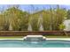 Beautiful pool with bamboo landscaping and a decorative water feature, great for relaxing at 100 Essex Dr, Longwood, FL 32779