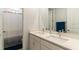 Double vanity bathroom with a shower/tub and a large mirror for convenience and functionality at 7418 Barrier Cove Way, Celebration, FL 34747
