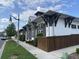 Attractive clubhouse exterior with dark shutters and supports, offering a distinctive and welcoming street presence at 7418 Barrier Cove Way, Celebration, FL 34747