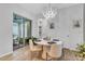 Dining area with modern chandelier, table setting, and sliding glass doors to a patio at 7418 Barrier Cove Way, Celebration, FL 34747