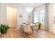 Bright dining space featuring modern chandelier, white table, and natural lighting at 7418 Barrier Cove Way, Celebration, FL 34747