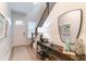 Bright foyer featuring a staircase, wood floors, and stylish console table at 7418 Barrier Cove Way, Celebration, FL 34747