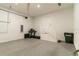 Spacious and clean garage with exercise equipment, overhead lighting, and epoxy flooring at 7418 Barrier Cove Way, Celebration, FL 34747