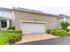 Detached two-car garage with manicured landscaping providing curb appeal and parking at 7418 Barrier Cove Way, Celebration, FL 34747