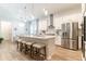 Open-concept kitchen boasts stainless appliances, large island with seating, and bright lighting at 7418 Barrier Cove Way, Celebration, FL 34747