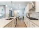 Modern kitchen featuring stainless steel appliances, an island, and wood-look flooring at 7418 Barrier Cove Way, Celebration, FL 34747