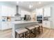 Modern kitchen featuring white cabinets, stainless steel appliances, and granite countertops at 7418 Barrier Cove Way, Celebration, FL 34747