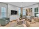 Bright living room featuring modern furnishings, a large TV, and elegant décor at 7418 Barrier Cove Way, Celebration, FL 34747