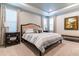 Main bedroom features a tray ceiling, a patterned bedspread, and matching bedside tables at 7418 Barrier Cove Way, Celebration, FL 34747