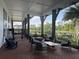 Covered outdoor seating area with comfortable furniture and scenic lake views, perfect for relaxation at 7418 Barrier Cove Way, Celebration, FL 34747