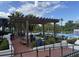 Inviting poolside lounge area with shaded pergola, offering a relaxing space for residents to enjoy at 7418 Barrier Cove Way, Celebration, FL 34747