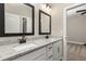 Elegant bathroom featuring a double sink vanity with granite countertops and modern black hardware at 7756 Somersworth Dr, Kissimmee, FL 34747