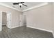 Spacious bedroom featuring a ceiling fan, with a closet and ensuite bathroom access, providing comfort and convenience at 7756 Somersworth Dr, Kissimmee, FL 34747
