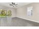 Bright living room with sliding glass doors, ceiling fan, and sleek wood flooring offers seamless indoor-outdoor living at 7756 Somersworth Dr, Kissimmee, FL 34747
