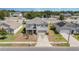This aerial view shows a well-maintained home in a quiet suburban neighborhood with green lawns and mature trees at 5597 Forest Ridge Dr, Winter Haven, FL 33881