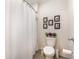 Clean bathroom featuring a toilet, shower with curtain, and tasteful decor at 5597 Forest Ridge Dr, Winter Haven, FL 33881