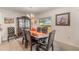 Elegant dining room with dark wood furniture, a china cabinet, and natural light at 5597 Forest Ridge Dr, Winter Haven, FL 33881