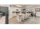 Spacious kitchen with white cabinetry, a large island with seating, and stainless steel appliances at 5597 Forest Ridge Dr, Winter Haven, FL 33881