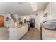 Kitchen featuring stainless steel appliances, an island with sink and white cabinets at 5597 Forest Ridge Dr, Winter Haven, FL 33881