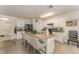 Bright kitchen features a center island with bar seating and white cabinetry at 5597 Forest Ridge Dr, Winter Haven, FL 33881