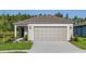 Charming single Gathering home features a neutral paint scheme, manicured lawn, and a large two car garage at 9072 Wildlight Trl, Wildwood, FL 34785