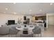 An open floor plan living space with a modern kitchen featuring an island and dark wood cabinetry at 9072 Wildlight Trl, Wildwood, FL 34785