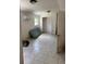 A bedroom features tile floor, a window, closet and wall mounted AC unit at 10931 Pathfinder Trl, Lakeland, FL 33809