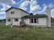A two-story home has neutral siding, and a chimney sits on the stuccoed section at 10931 Pathfinder Trl, Lakeland, FL 33809