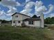 A two-story home has neutral siding, and a chimney sits on the stuccoed section at 10931 Pathfinder Trl, Lakeland, FL 33809