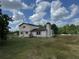 A two-story home has neutral siding, and a chimney sits on the stuccoed section at 10931 Pathfinder Trl, Lakeland, FL 33809