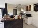 Kitchen features empty cabinets, a bar, and a stainless steel sink at 10931 Pathfinder Trl, Lakeland, FL 33809