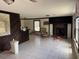 A living room features tile floors, paneled accent wall, fireplace and accent chair at 10931 Pathfinder Trl, Lakeland, FL 33809