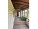 This porch features wood flooring, a bench, and view of the yard at 10931 Pathfinder Trl, Lakeland, FL 33809