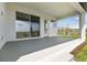 Spacious covered patio with sliding glass doors and outdoor seating area for entertaining at 16998 Cedar Valley Cir, Clermont, FL 34711