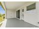 Covered back porch with a sliding glass door and a window, offering a pleasant outdoor living space at 16998 Cedar Valley Cir, Clermont, FL 34711