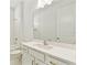 Bright bathroom featuring an expansive vanity with gold hardware and sleek tile at 16998 Cedar Valley Cir, Clermont, FL 34711