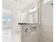 Bright bathroom featuring sleek tile shower with a glass partition and a modern vanity at 16998 Cedar Valley Cir, Clermont, FL 34711