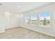 Bright bedroom featuring large windows with scenic views and light-colored modern floors at 16998 Cedar Valley Cir, Clermont, FL 34711