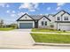 Charming single-story home with a well-manicured lawn and a gray garage door at 16998 Cedar Valley Cir, Clermont, FL 34711