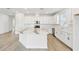 Bright, open kitchen with white cabinets, stainless steel appliances, and a marble-topped island at 16998 Cedar Valley Cir, Clermont, FL 34711