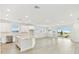 Open-concept kitchen with stainless steel appliances, island, and sliding glass doors at 16998 Cedar Valley Cir, Clermont, FL 34711