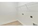 Bright laundry room features wood-look floors and convenient wire shelving, ready for your washer and dryer at 16998 Cedar Valley Cir, Clermont, FL 34711