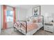 A light and airy bedroom with carpet, featuring feminine decor and natural light from the window at 5686 Portico Pl, Kissimmee, FL 34758