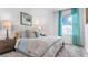 Bright bedroom featuring a plush bed with neutral colored headboard and abundant natural light from the large window at 5686 Portico Pl, Kissimmee, FL 34758
