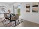 Cozy dining area featuring a round table, stylish chairs, rug and sliding doors to the backyard at 5686 Portico Pl, Kissimmee, FL 34758