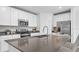 Modern kitchen featuring stainless steel appliances, sleek countertops, and a large island with seating at 5686 Portico Pl, Kissimmee, FL 34758