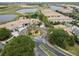 Overhead view showcasing the clubhouse, pool, and nearby townhomes within a lush, green golf course community at 1209 Payne Stewart Dr, Davenport, FL 33896